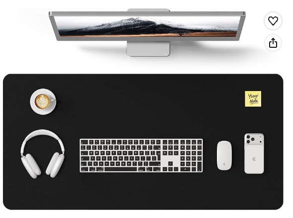 Black YSAGi leather desk pad arranged beneath a monitor with a keyboard, mouse, headphones, and phone.